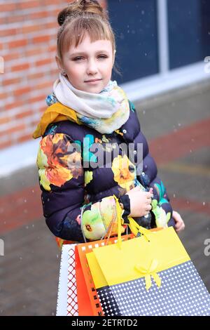 A girl with a lot of packages in her hands. Stock Photo