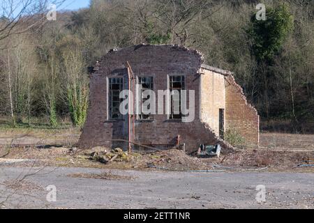 old building. Most has already been demolished and the remains has broken windows and loose brickwork. There is no people in the photo Stock Photo