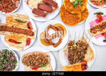 Collage or Set of Turkish food in Turkish restaurant at dinner table. Kebab, lahmacun, sucuk and salads. Stock Photo