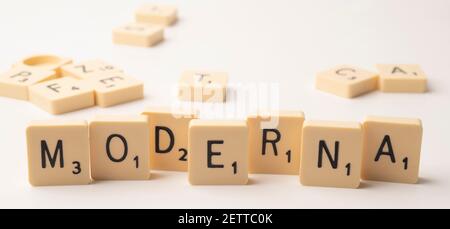 Coronavirus pandemic themed scrabble game word tiles on white with background tiles Stock Photo