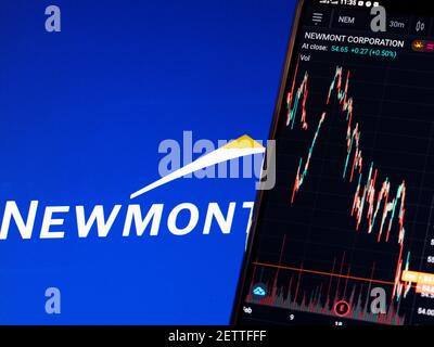 In this photo illustration the stock market information of Newmont Corporation displays on a smartphone while the logo of Newmont Corporation displays as the background Stock Photo