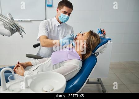 Examination of female teeth by a dentist Stock Photo