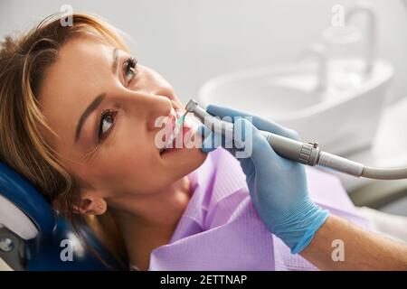 Pretty woman under a tooth polishing procedure Stock Photo