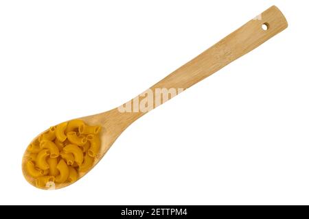 Top view of a portion of organic elbow macaroni on a wood kitchen spoon isolated on a white background. Stock Photo