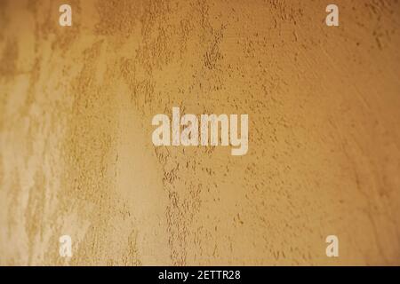 Golden wall plaster close-up. Decorative Venetian plaster Stock Photo
