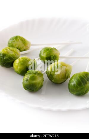 Set of brussel sprouts with lollipop sticks on white background Stock Photo