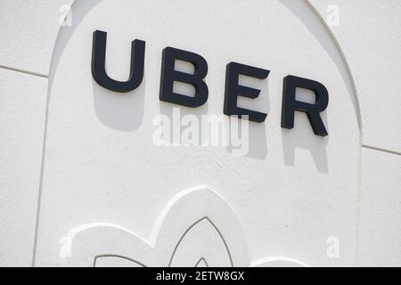 A logo sign outside of a Uber Technologies regional office in 