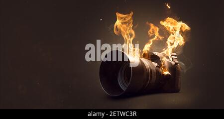 Camera on fire with actual flames Stock Photo