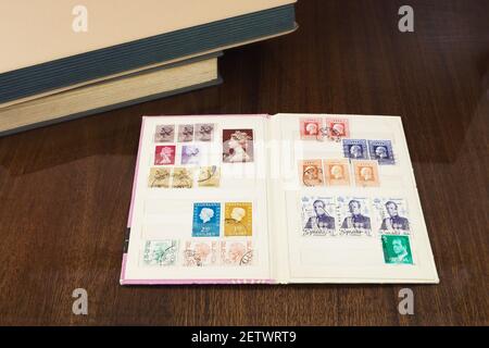 Collection of postage stamps with portrait of royal persons in book of stamps Stock Photo