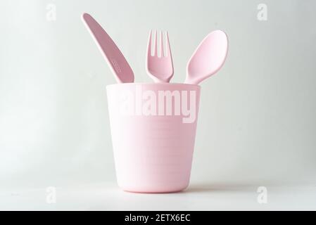 Plastic cup, spoon, fork and a knife isolated on white background Stock Photo