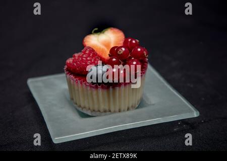 beautiful and tasty looking cheesecake on a black background, front view Stock Photo