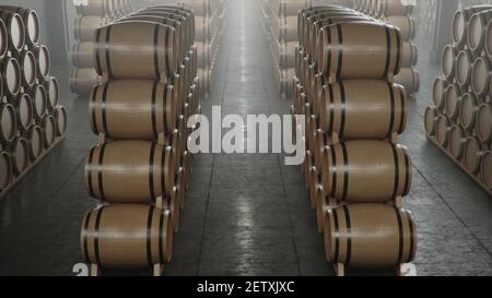 Barrels of wine, whiskey, bourbon liqueur or cognac in the basement. Aging of alcohol in oak barrels in warehouse. Wine, beer, whiskey casks stacked i Stock Photo