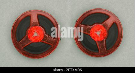 Music and films on old tapes. Analog sound. The bobbins are red. Retro style. Stock Photo
