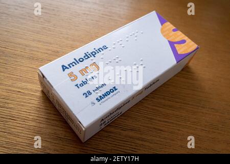 A detailed view of a box of 5mg Amlodipine manufactured by the pharmaceutical Sandoz, a Novartis company, on 1st March 2021, in London, England. Amlodipine is known as a Calcium Blocker used for the reduction of Hypertension (high blood pressure). Stock Photo