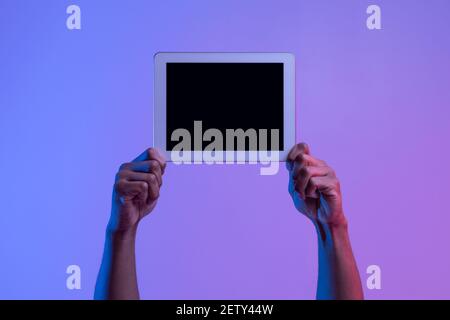 Hands Of African American Man Holding Digital Tablet With Black Blank Screen Stock Photo