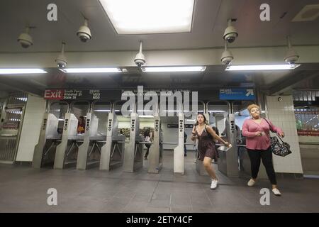 Passengers swipe through the turnstiles in the newly restored South Ferry subway station in New York on re-opening day Tuesday, June 27, 2017. The restored station was closed after catastrophic damage by Superstorm Sandy with an estimated 15 million gallons of water flooding the terminal which cost $545 million and was only open three years. The $340 million in repairs were finished today nearly five years after Superstorm Sandy. In the interim the Number One train used the quirky old South Ferry loop which only accommodated the first five cars of a ten car train. (Photo by Richard B. Levine) 