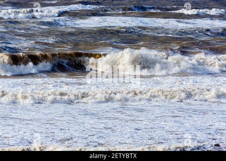 Breaking waves and surf in the rough sea off Hanover Point in the Isle of Wight during bad weather with storm force heavy winds Stock Photo