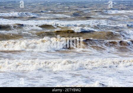 Breaking waves and surf in the rough sea off Hanover Point in the Isle of Wight during bad weather with storm force heavy winds Stock Photo