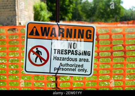 A warning sign indicating no trespassing indicating a hazardous area. Stock Photo