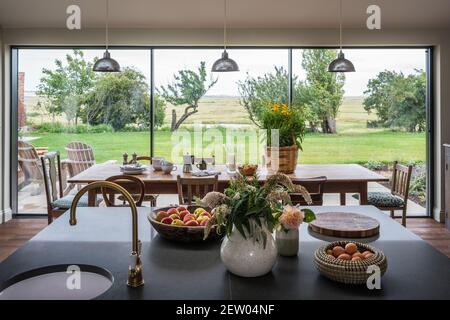 Open plan kitchen by Tom Dunn in off-grid farmhouse renovation. Stock Photo