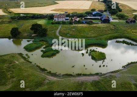 Off-grid farmhouse at lakeside in Elmley nature reserve. Stock Photo
