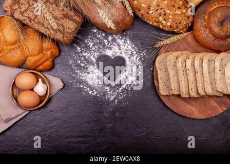 Various of rye bread on a dark background. Copy space. Love cooking. Stock Photo