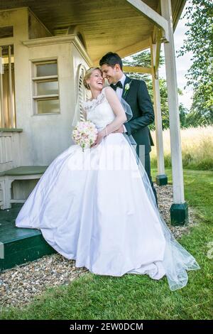 Bride and Bridegroom happily together, facing each other with big smiles Stock Photo