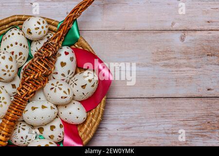 Willow branches with colorful ribbons.Easter Eggs in basket banner.Above view with copy space for text.Happy Easter decoration background,hand painted Stock Photo
