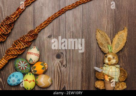 Colorful Easter Eggs,bunny,willow branches banner.Above view with copy space.Happy Easter decoration background,colorful hand painted decorated eggs. Stock Photo