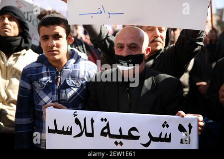 February 26, 2021: Azaz, Syria. 26 February 2021. A demonstration against Syrian President Bashar al-Assad is held in the city of Azaz, in north western Syria, under the title â€œThere is no legitimacy for Assad and his electionsâ€. Protesters held banners denying legitimacy to the Syrian President Bashar al-Assad and the forthcoming presidential elections, while also calling for the release of members of the opposition arrested by the Syrian government. Some placards denounced Bashar al-Assad for using chemical weapons, with a banner reminding of the chemical attack in Ghouta on 21 August 20 Stock Photo