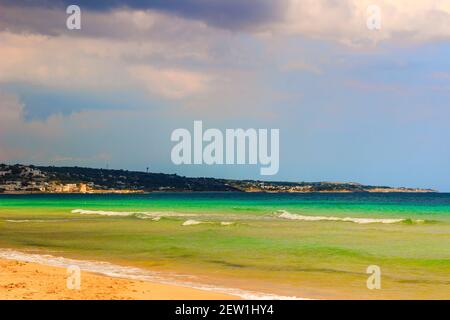 The most beautiful sandy beaches of Apulia (Italy): Pescoluse, the Maldives of Salento. In the background the marine of Torre Vado. Stock Photo