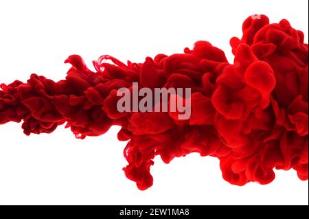 Red acrylic ink in water on white isolated background frozen motion very close up. Abstract background, color explosion Stock Photo
