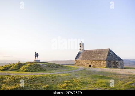 France, Finistere, Saint Rivoal, hikers in the Monts d'Arrée on the Mont Saint-Michel-de-Braspart and his chapel at sunset (aerial view) Stock Photo