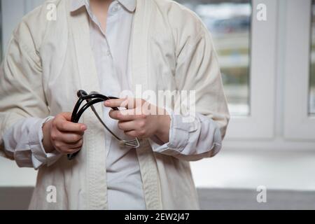A young female doctor holds a stethoscope. Stock Photo
