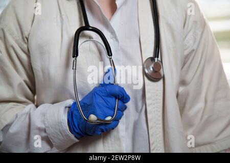 A female doctor holds a stethoscope in her hand.  Stock Photo