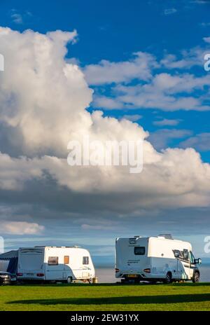 Caravans and Camper vans at the campsite at Three Cliffs Bay on the south coast of the Gower Peninsula near Swansea in South Wales UK Stock Photo