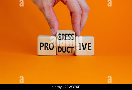 Productive and progressive symbol. Businessman turns cubes and changes the word 'progressive' to 'productive'. Beautiful orange background, copy space Stock Photo