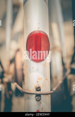 The red reflectors on the back of the vintage bicycle are used as illustrations for the text and used as backgrounds, presented in vintage tone patter Stock Photo