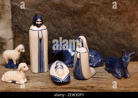 Blue and white ceramic nativity set with Holy Family Mary Jesus and Joseph in Bethlehem stable on fireplace mantelpiece Stock Photo