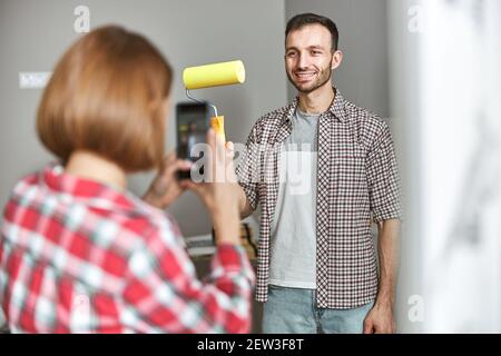 Joyous worker posing for the smartphone camera in the workplace Stock Photo