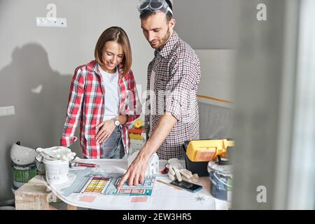 Two people discussing a technical drawing of a building Stock Photo