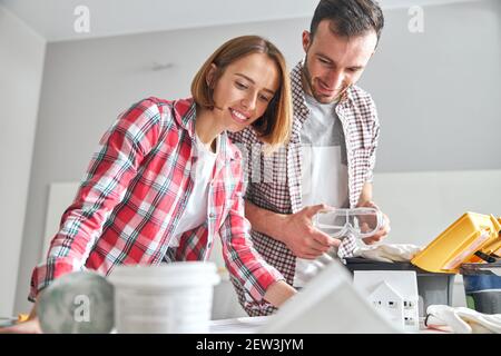 Two young Caucasian architects studying a blueprint Stock Photo