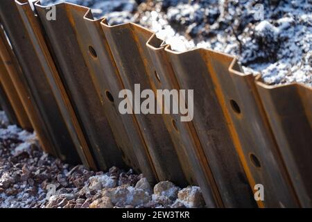 Sheet metal, piling, position, located in ground, supporting, river banks, interlocking edges, driven into ground, earth retention excavation support. Stock Photo