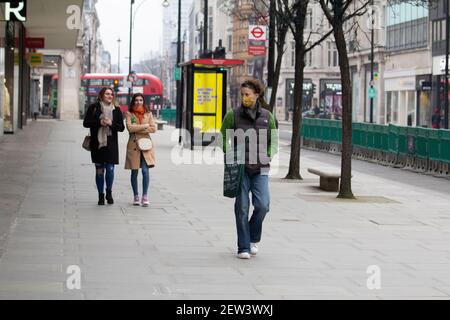 Oxford Street London, during Coronavirus Covid-19 Pandemic lockdown Pedestrians in quiet streets wearing ppe masks Stock Photo