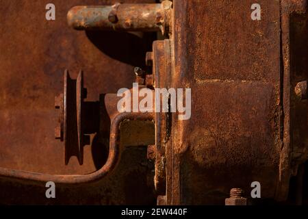 Rusty metal parts belonging to an old abandoned and disused tractor, formerly used in the agronomic industry, near Campo de Borja, Zaragoza province, Stock Photo