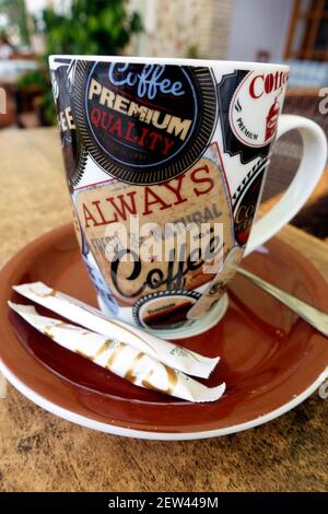 Coffee cup and saucer with sugar on the side in a cafe Stock Photo