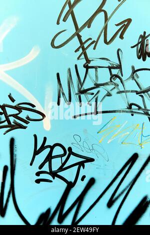 Spain - Dec 24, 2020: Abstract graffiti on blue background wall Stock Photo