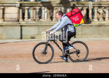 Just Eat fast food delivery cyclist in a city centre, UK Stock Photo