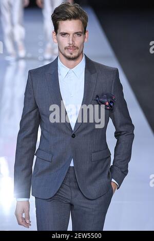 Model Mark Cox walks on the runway during the Emporio Armani