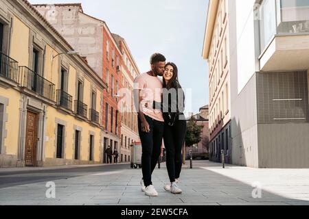Young couple having romantic moments together in the street. Multicultural couples concept Stock Photo